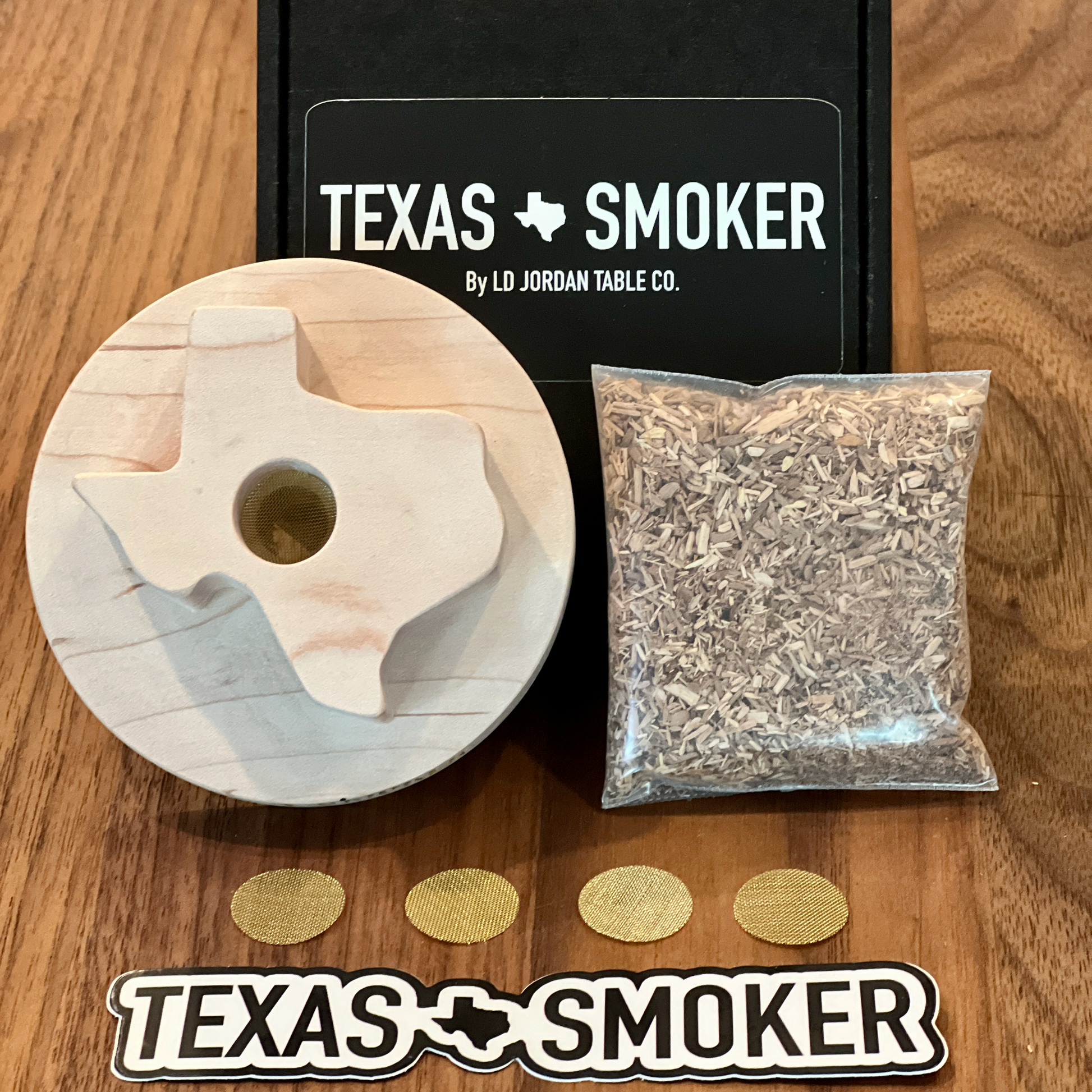 Bourbon and whiskey smoker includes Texas smoker, apple wood, smoker screens, and a Texas Smoker sticker. 